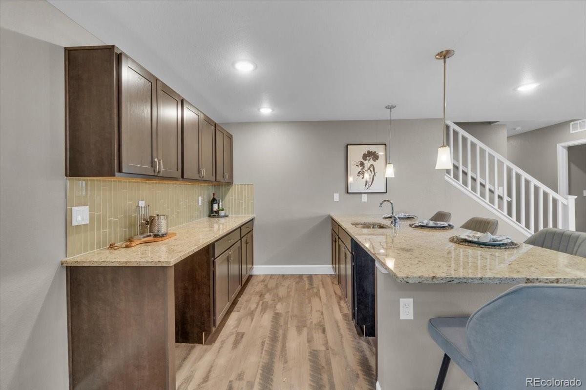 1721 Wingfeather Lane Castle Rock, CO 80108 - Photo 39 of 49 a kitchen with sink cabinets and wooden floor