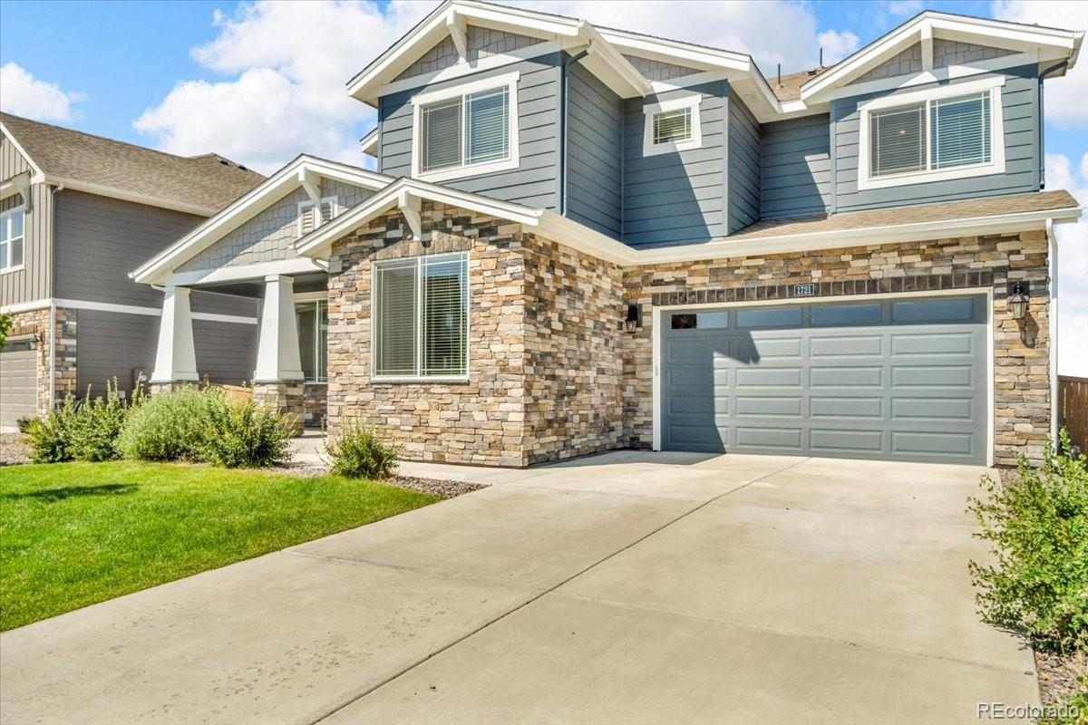 1721 Wingfeather Lane Castle Rock, CO 80108 - Photo 45 of 49 a front view of a house with a yard and garage