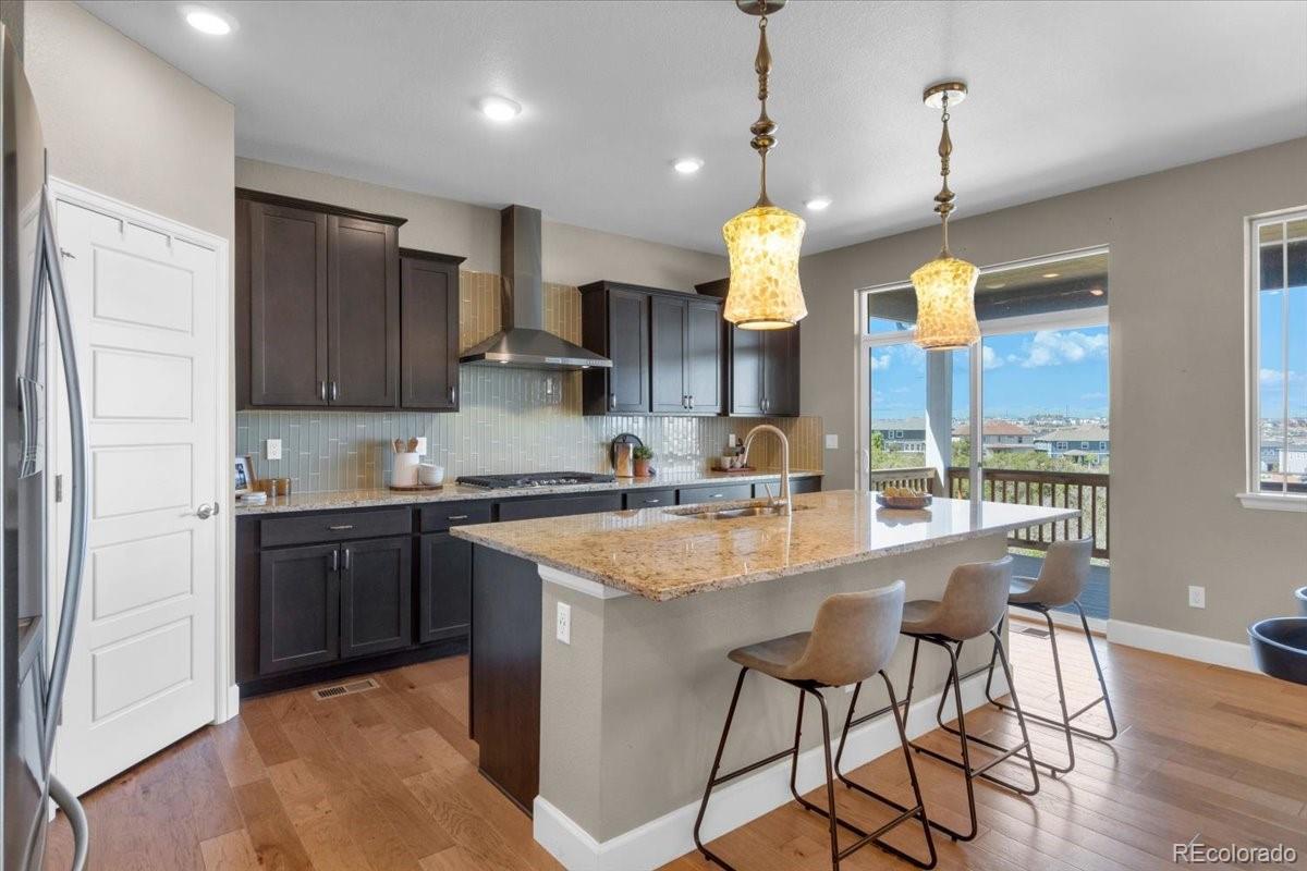 1721 Wingfeather Lane Castle Rock, CO 80108 - Photo 6 of 49 a large kitchen with granite countertop lots of counter top space and appliances