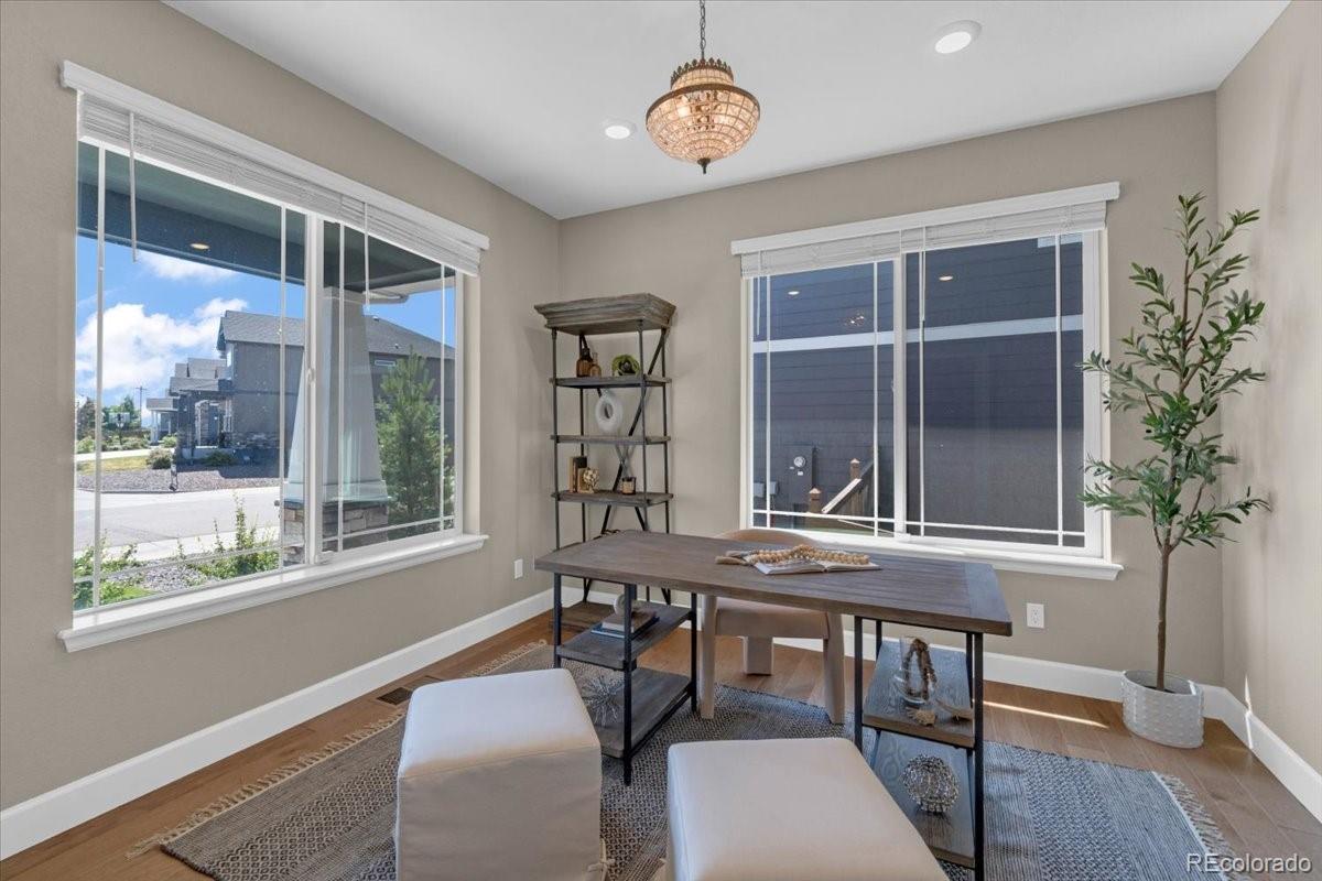 1721 Wingfeather Lane Castle Rock, CO 80108 - Photo 10 of 49 a view of a dining room with furniture window and wooden floor