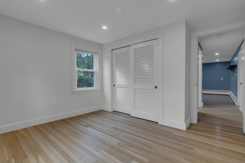 104 Mishawum Road Woburn, MA 01801 - Photo 4 of 13 wooden floor in an empty room with a window
