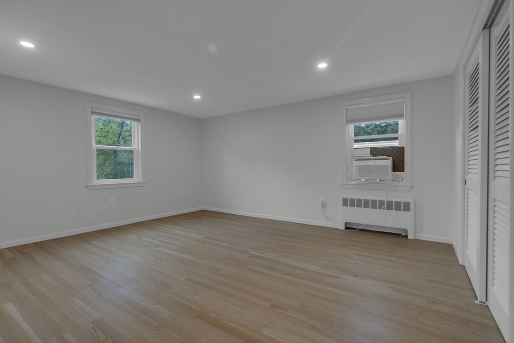 104 Mishawum Road Woburn, MA 01801 - Photo 5 of 13 an empty room with windows and closet
