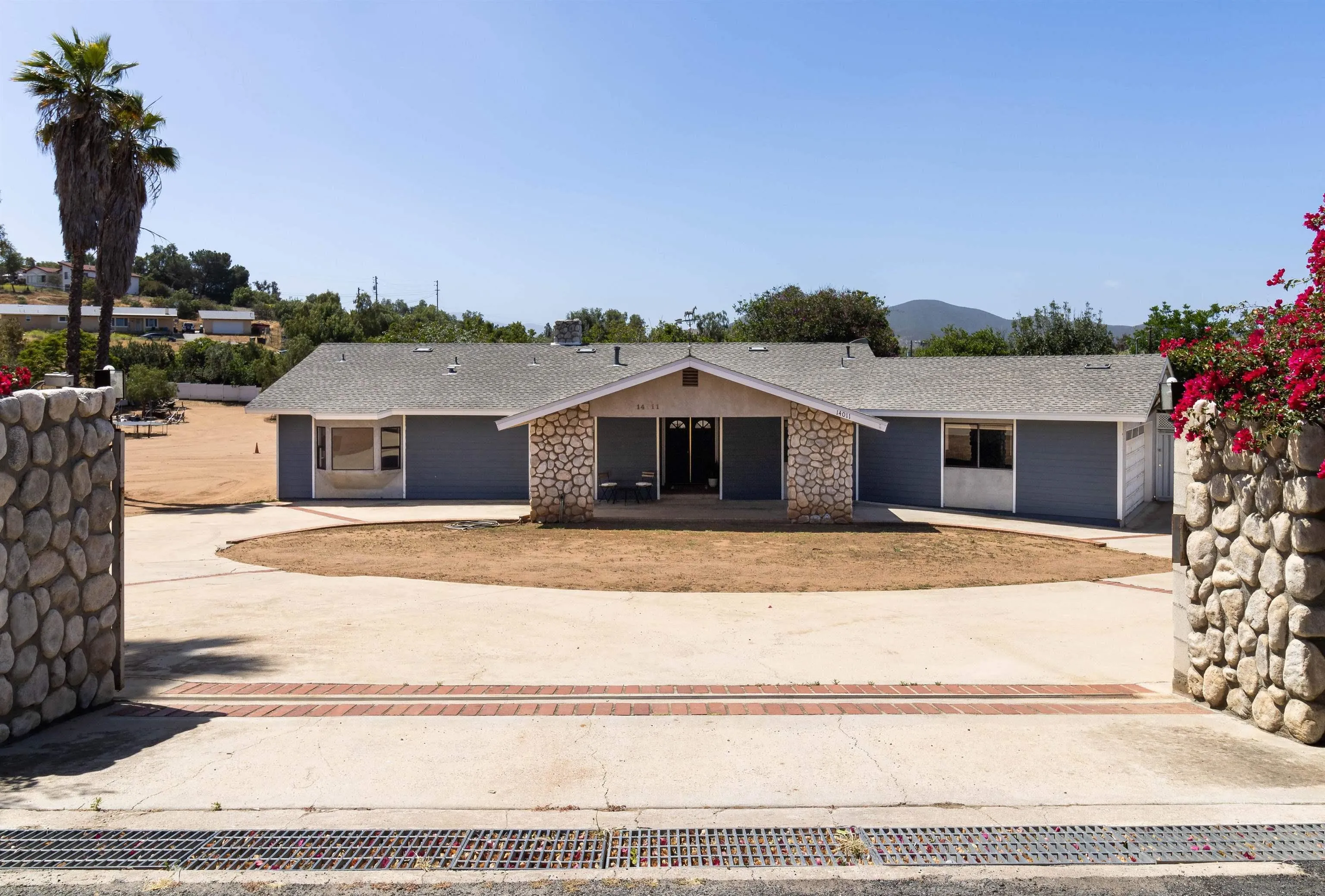 14011 Proctor Valley Road Jamul, CA 91935 - Photo 1 of 36 a front view of a house with a yard and garage