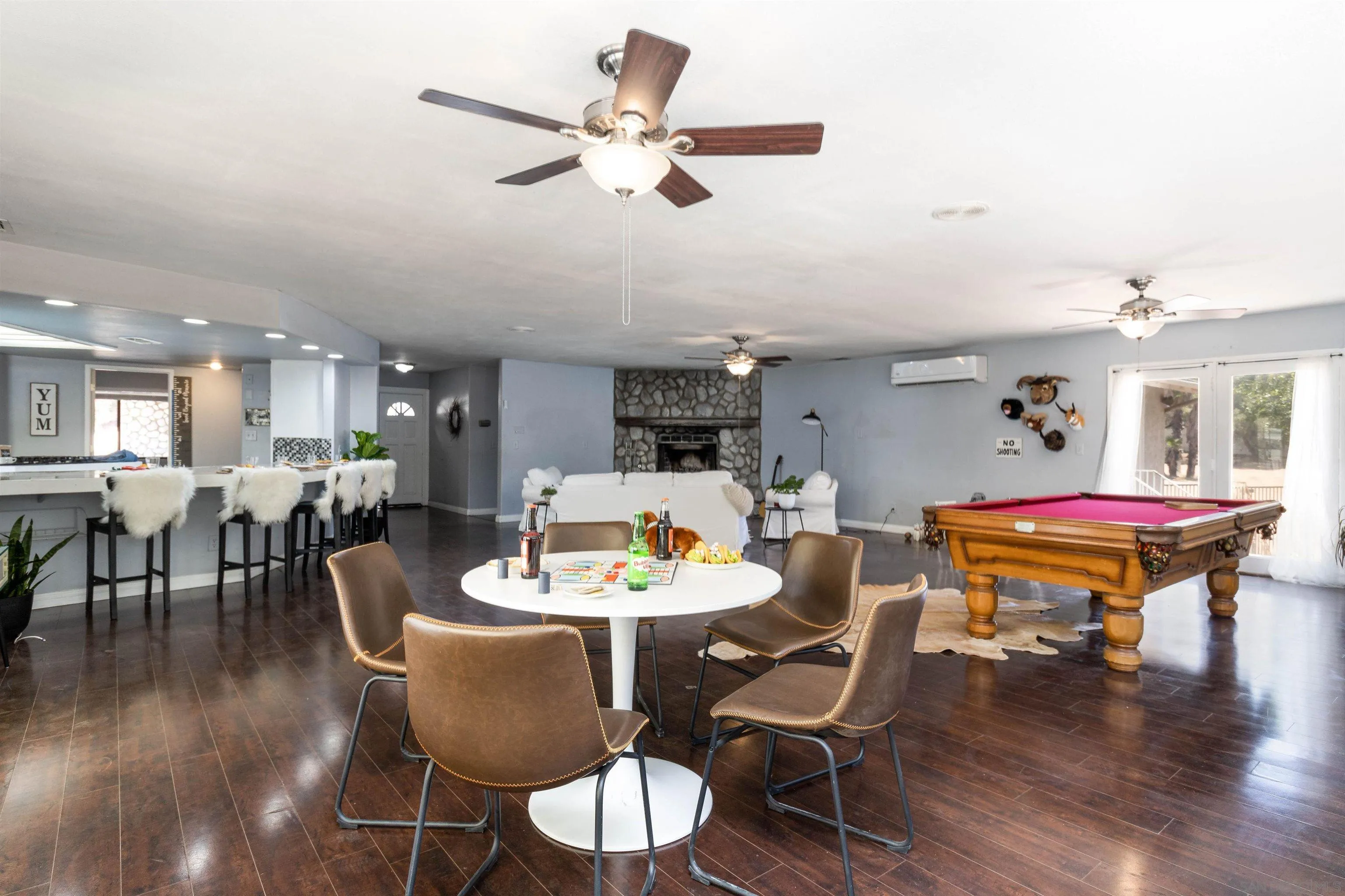 14011 Proctor Valley Road Jamul, CA 91935 - Photo 11 of 36 a dining room with wooden floor a glass table and chairs