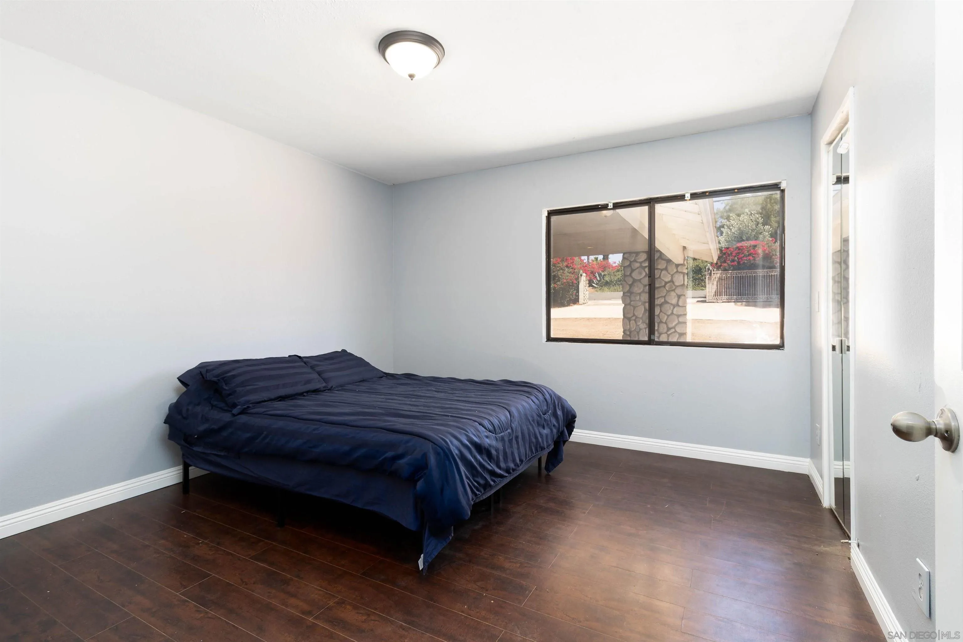 14011 Proctor Valley Road Jamul, CA 91935 - Photo 14 of 36 a bedroom with a bed and a window