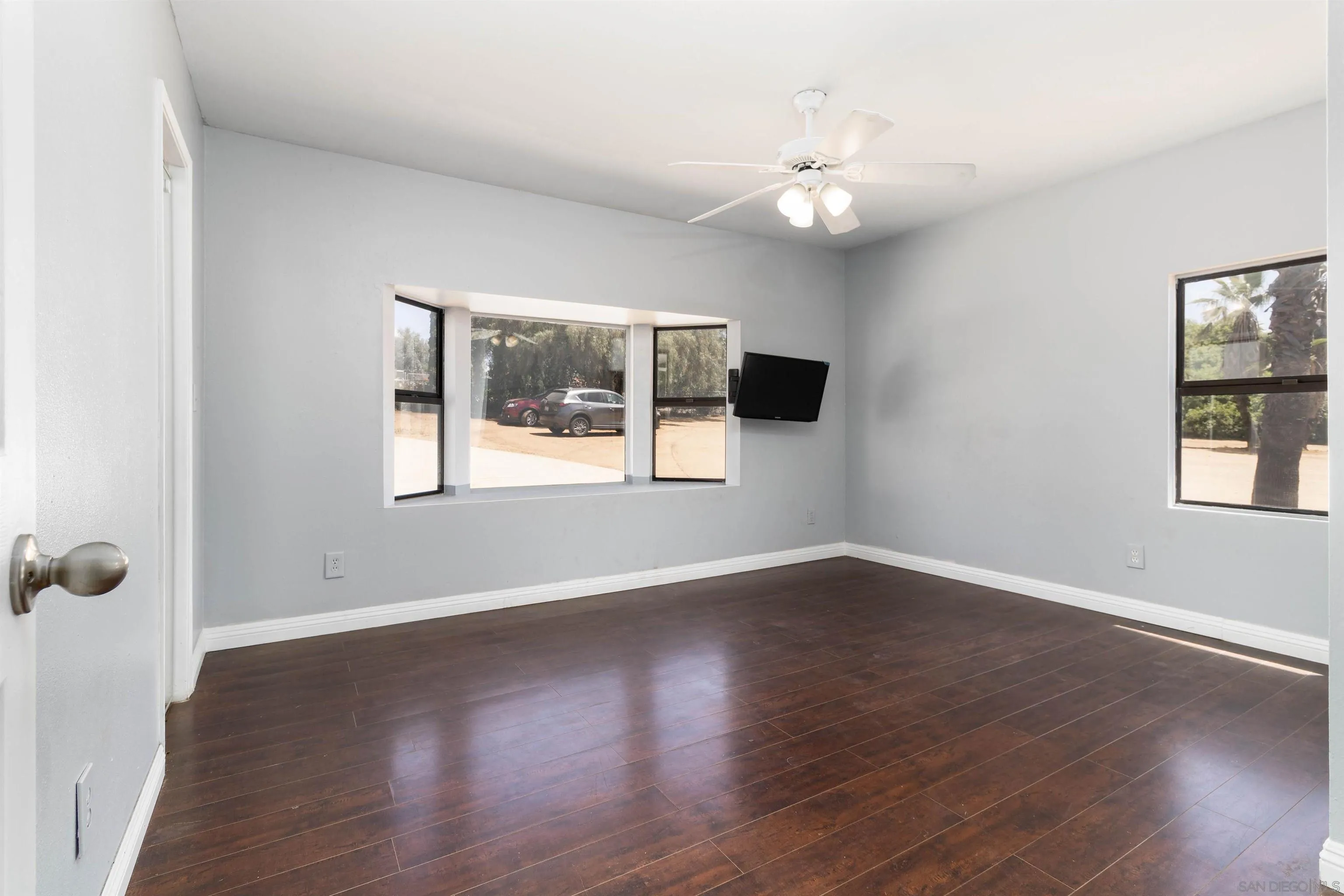 14011 Proctor Valley Road Jamul, CA 91935 - Photo 15 of 36 a view of an empty room with wooden floor and a window