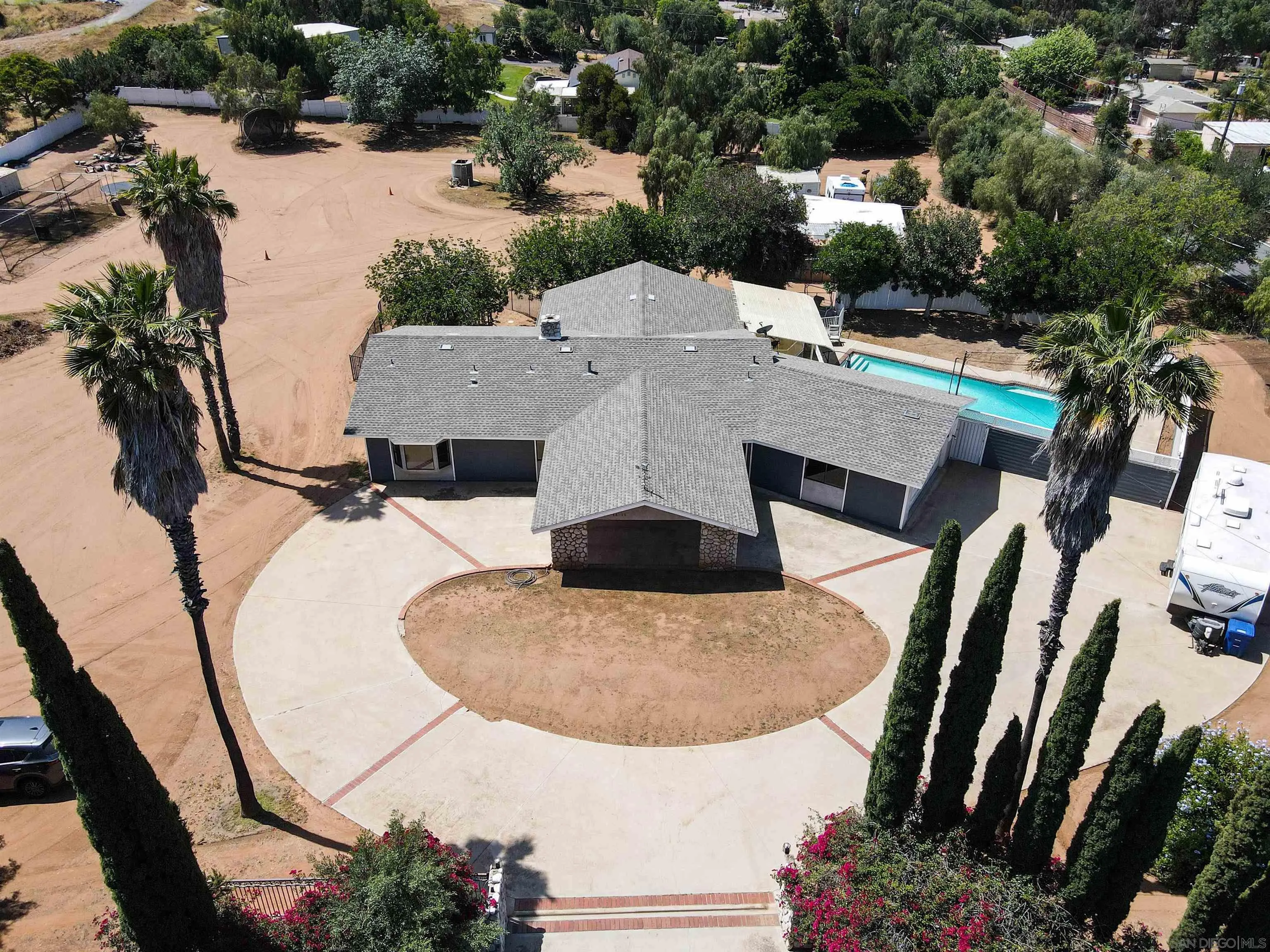 14011 Proctor Valley Road Jamul, CA 91935 - Photo 2 of 36 an aerial view of a house with swimming pool and lake view