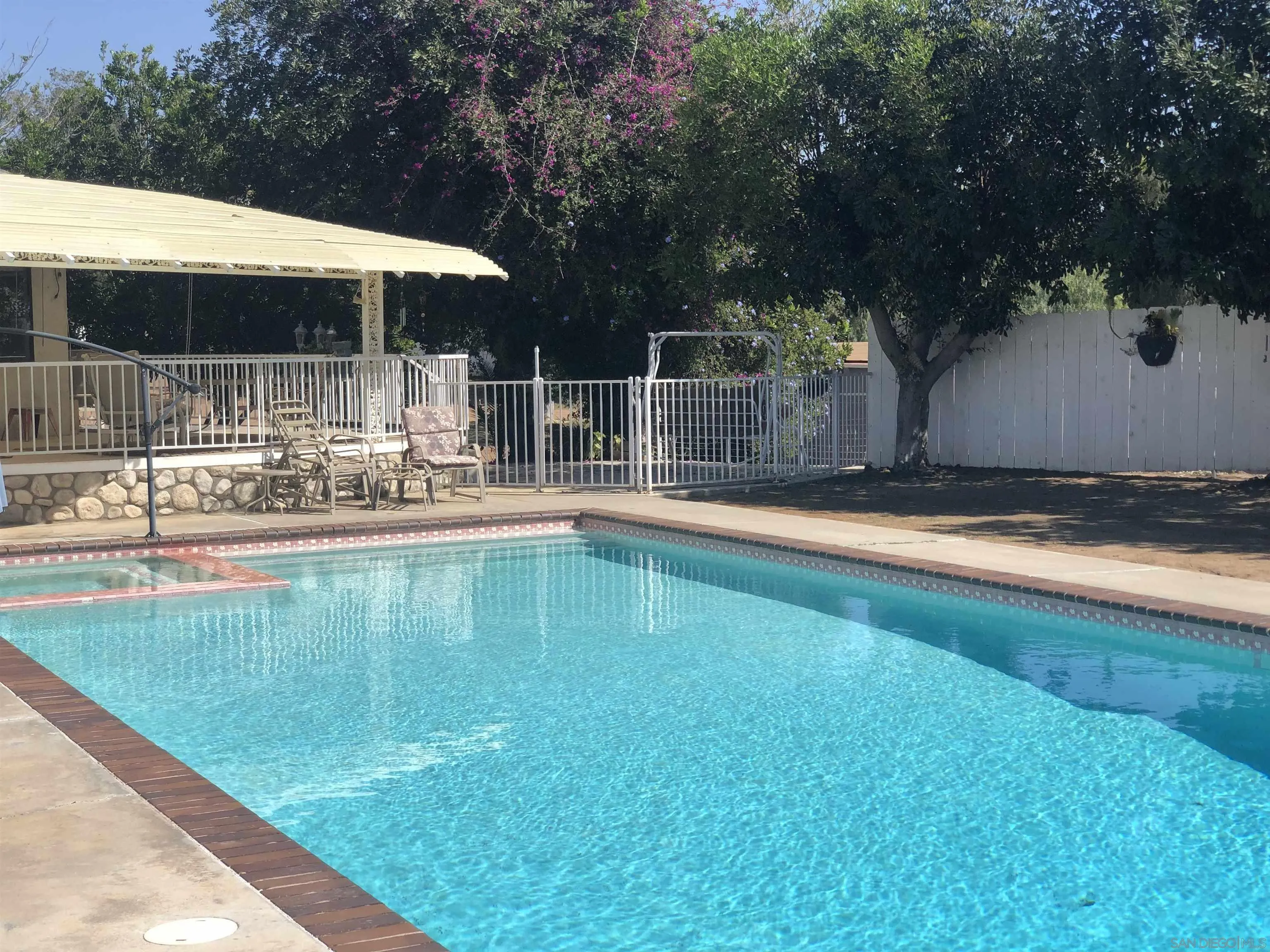 14011 Proctor Valley Road Jamul, CA 91935 - Photo 23 of 36 a swimming pool with outdoor seating and yard