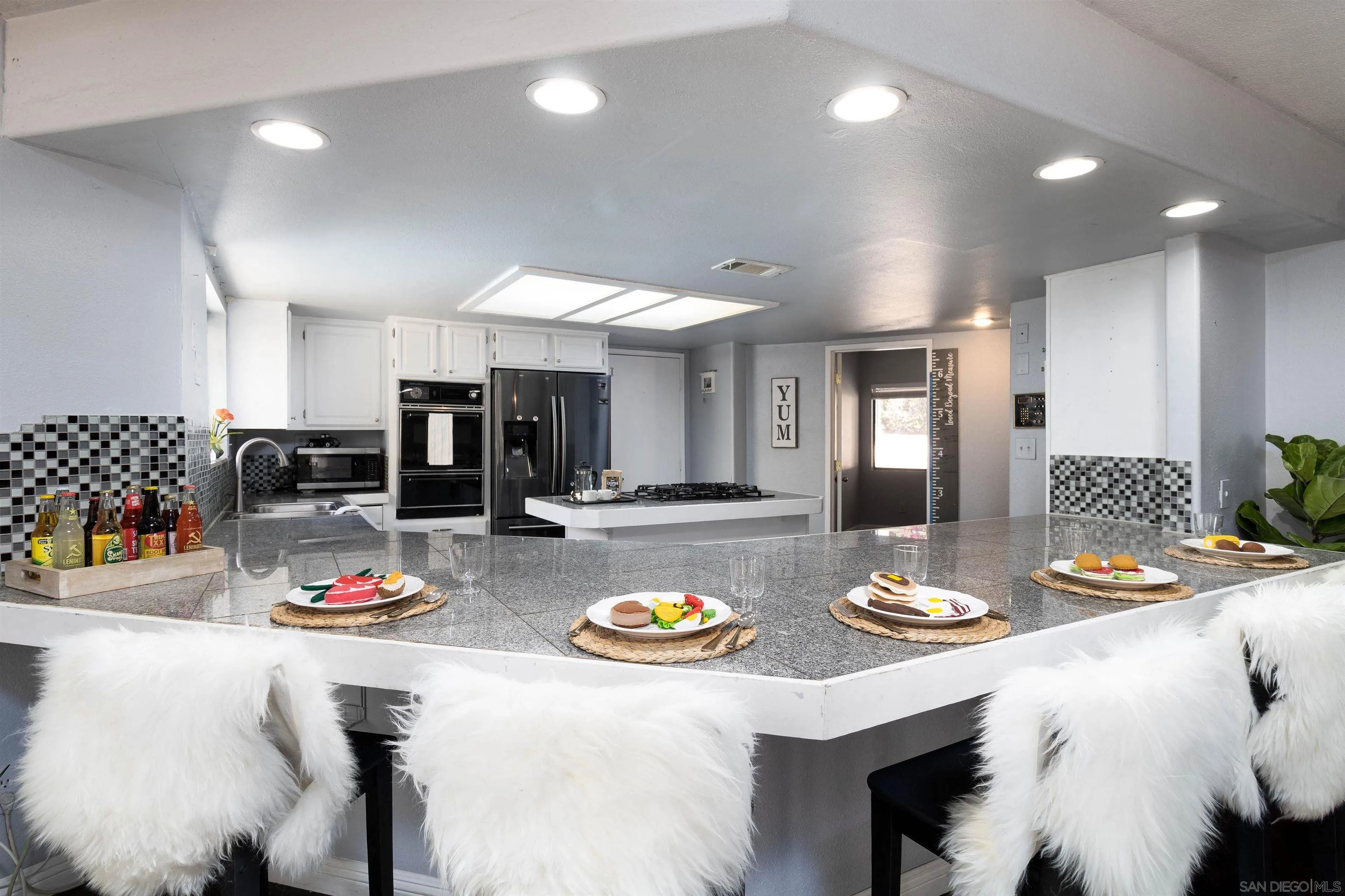 14011 Proctor Valley Road Jamul, CA 91935 - Photo 8 of 36 a kitchen with a dining table and chairs