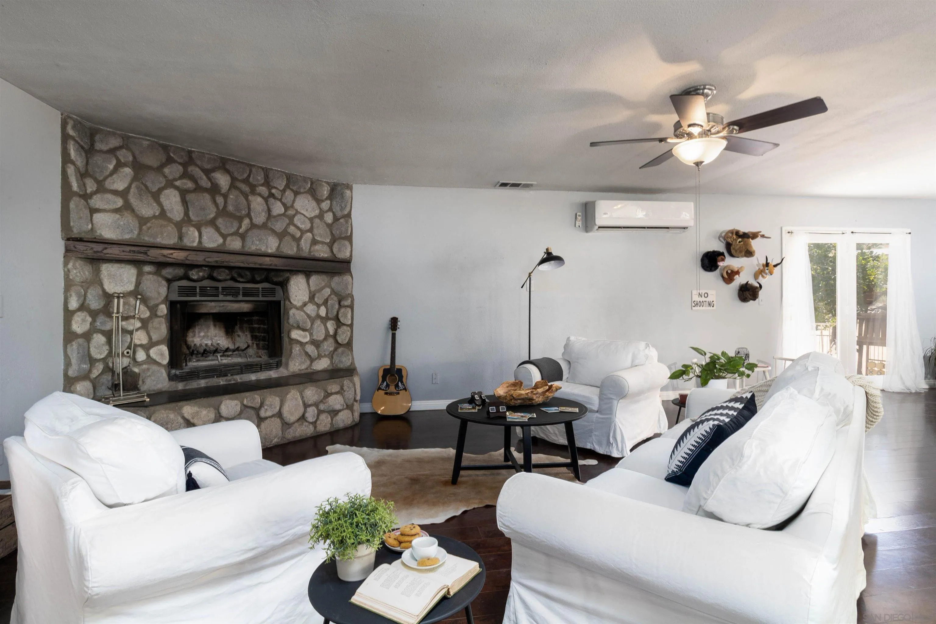 14011 Proctor Valley Road Jamul, CA 91935 - Photo 9 of 36 a living room with furniture a fireplace and a chandelier
