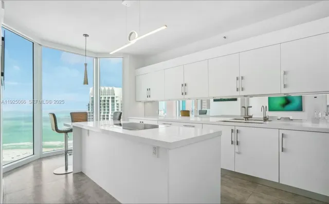 a kitchen with a sink window and cabinets