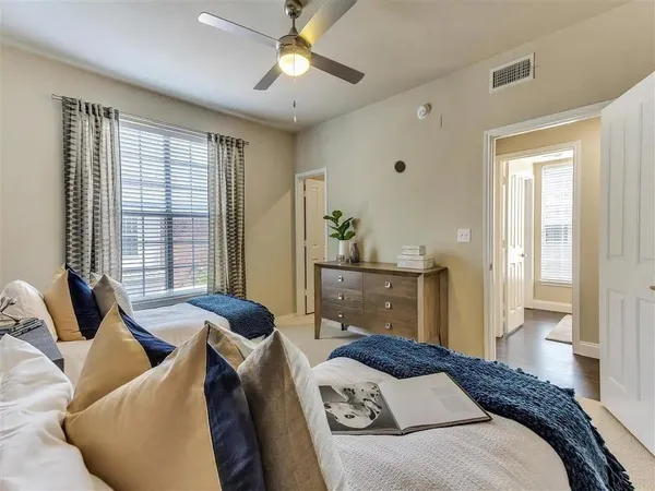 a bedroom with a bed and glass window