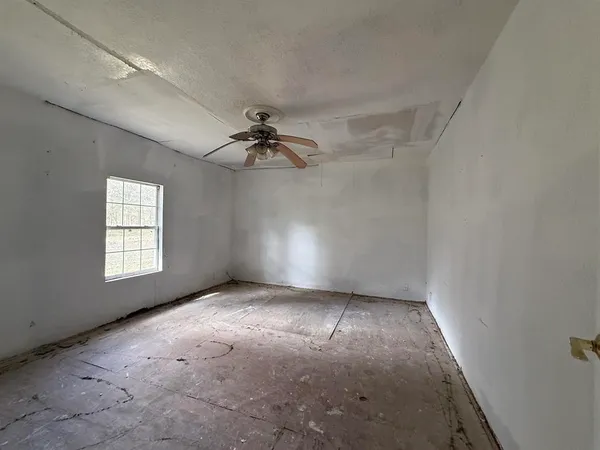 a view of an empty room with windows