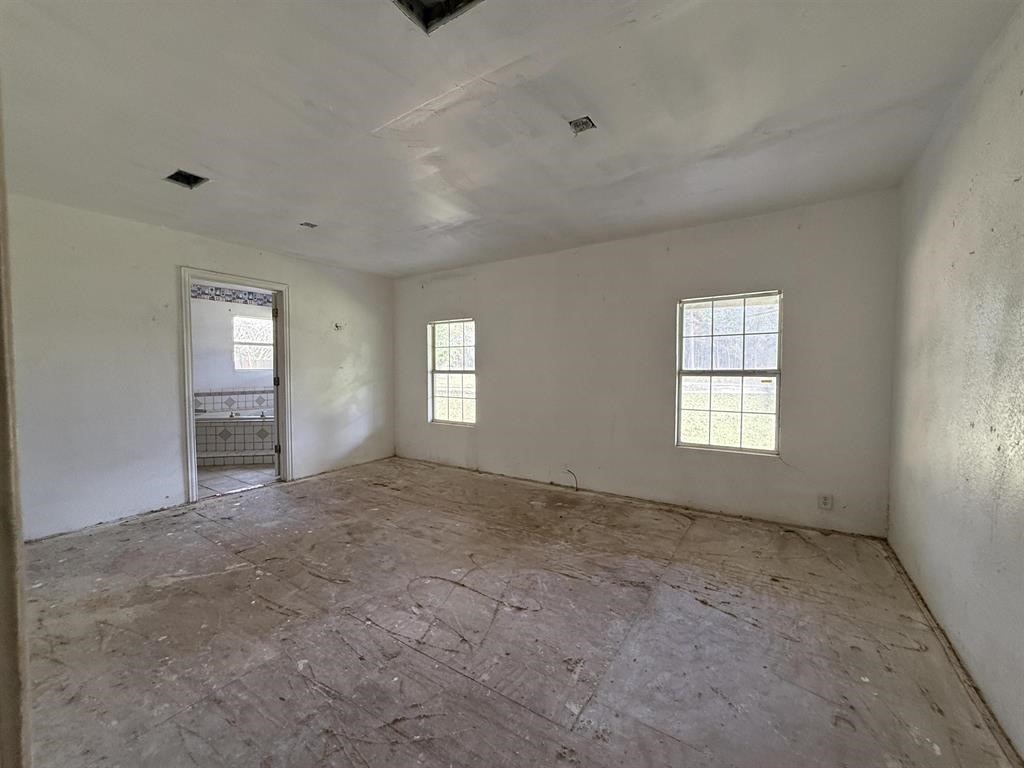9283 Largent Road Hull, TX 77564 - Photo 15 of 22 a view of an empty room with windows