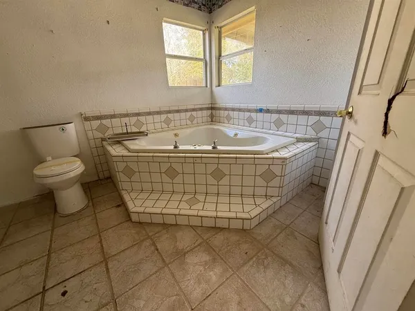 a spacious bathroom with a toilet sink and a mirror