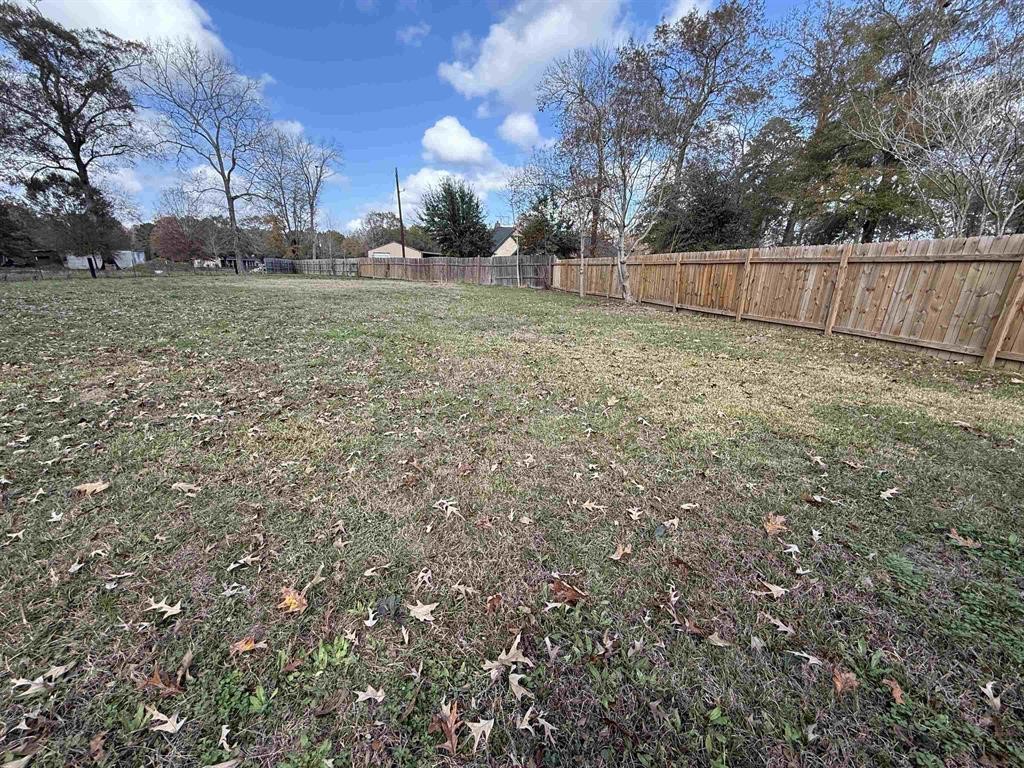 9283 Largent Road Hull, TX 77564 - Photo 21 of 22 a view of a backyard with large trees and wooden fence