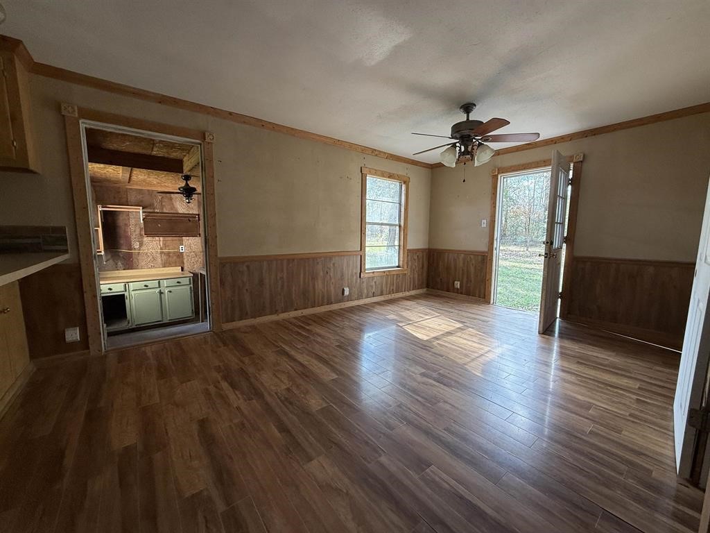 9283 Largent Road Hull, TX 77564 - Photo 7 of 22 an empty room with wooden floor and windows