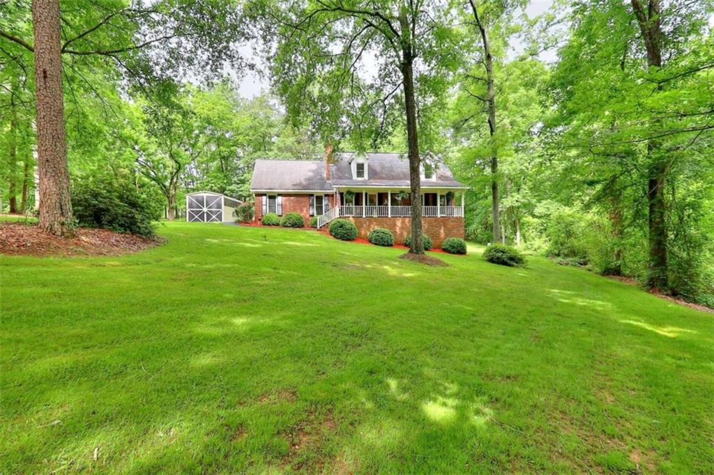1470 Mount Vernon Road Northwest Monroe, GA 30656 - Photo 1 of 1 a front view of a house with a garden