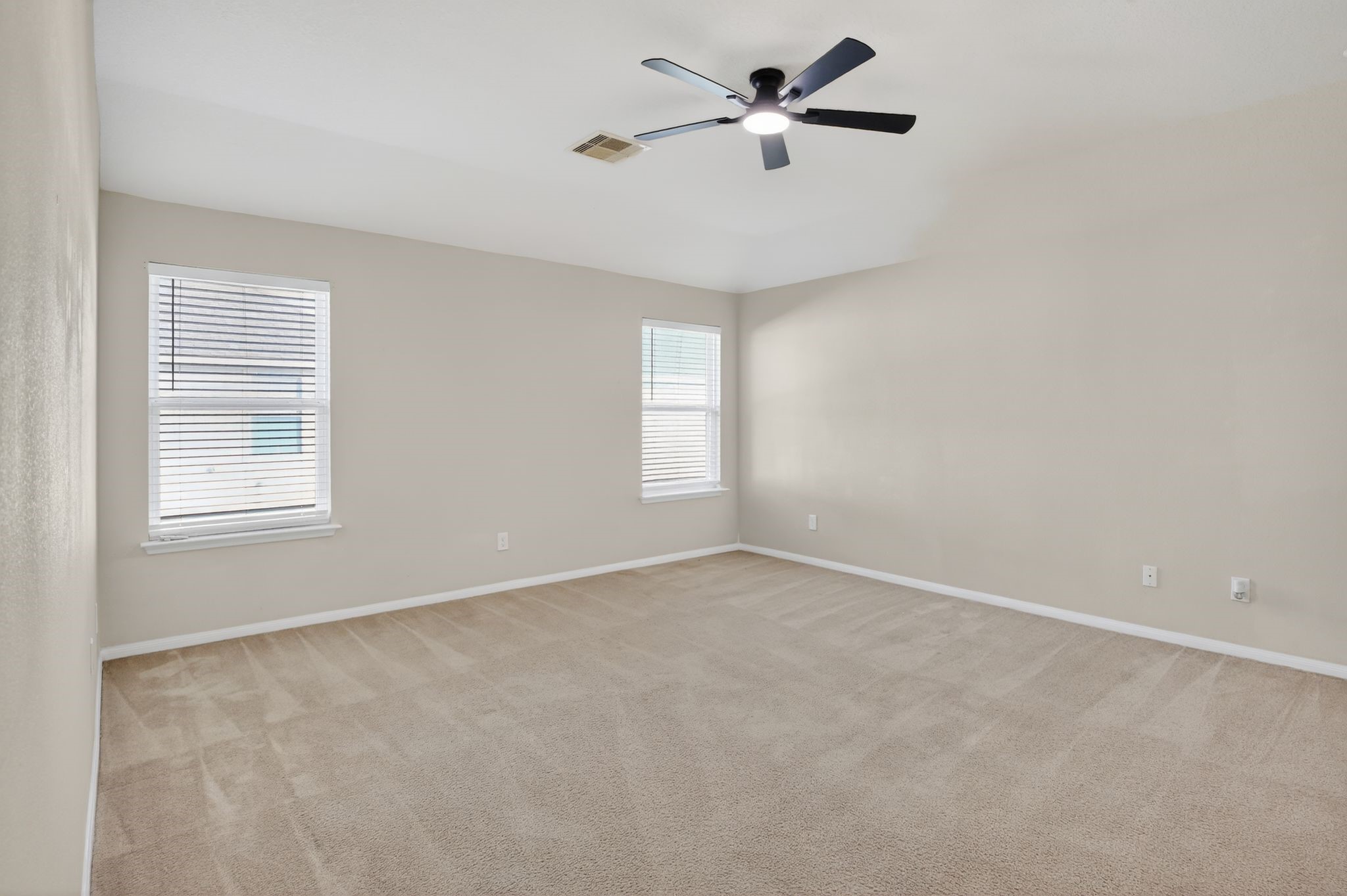 4938 Yearling Ridge Court Katy, TX 77449 - Photo 24 of 29 an empty room with windows and fan