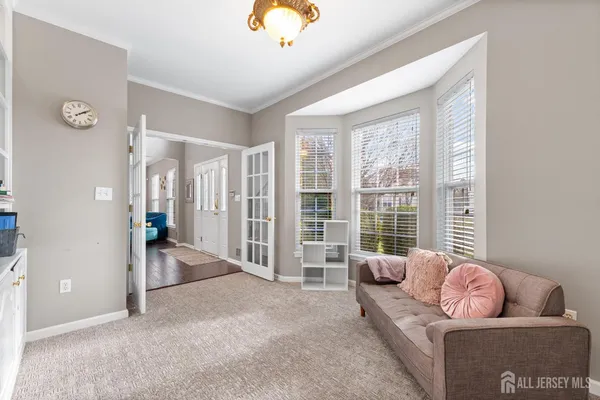 a living room with furniture and large windows