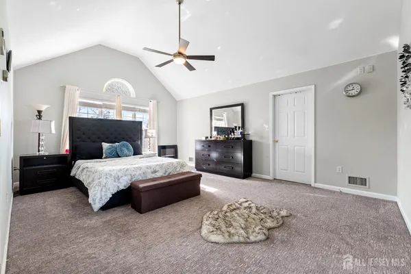 a bedroom with a bed couches and a fireplace