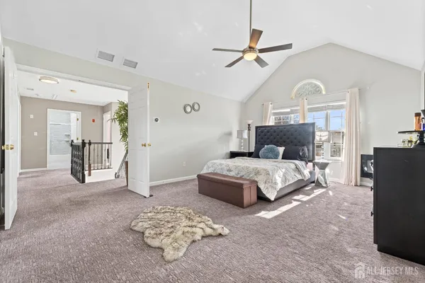 a bedroom with a bed mirror and a kitchen island