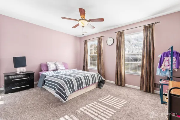 a bedroom with a bed and a television