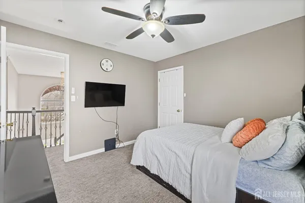 a bedroom with a bed and a tv