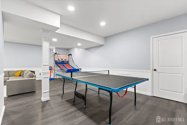 a view of a room with furniture and wooden floor