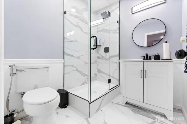 a bathroom with a toilet a sink and mirror