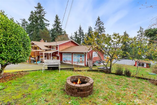 a front view of a house with a garden and trees