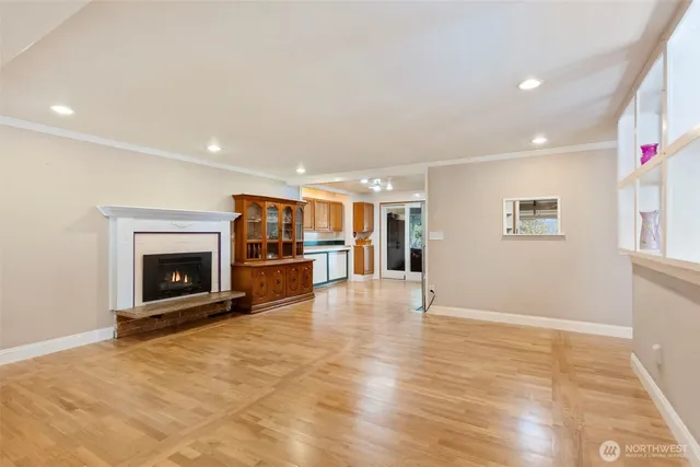 a view of an empty room with a fireplace and a window