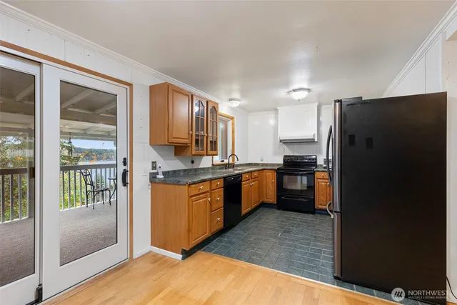 a kitchen with stainless steel appliances granite countertop a refrigerator and a sink