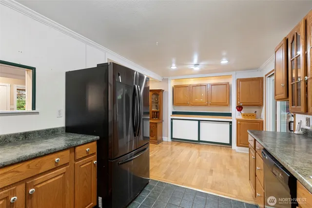 a kitchen with stainless steel appliances granite countertop a refrigerator and a stove top oven