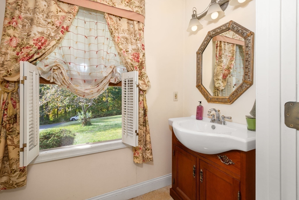 133 Dresser Hill Road Charlton, MA 01507 - Photo 13 of 42 a bathroom with a sink a mirror and a window