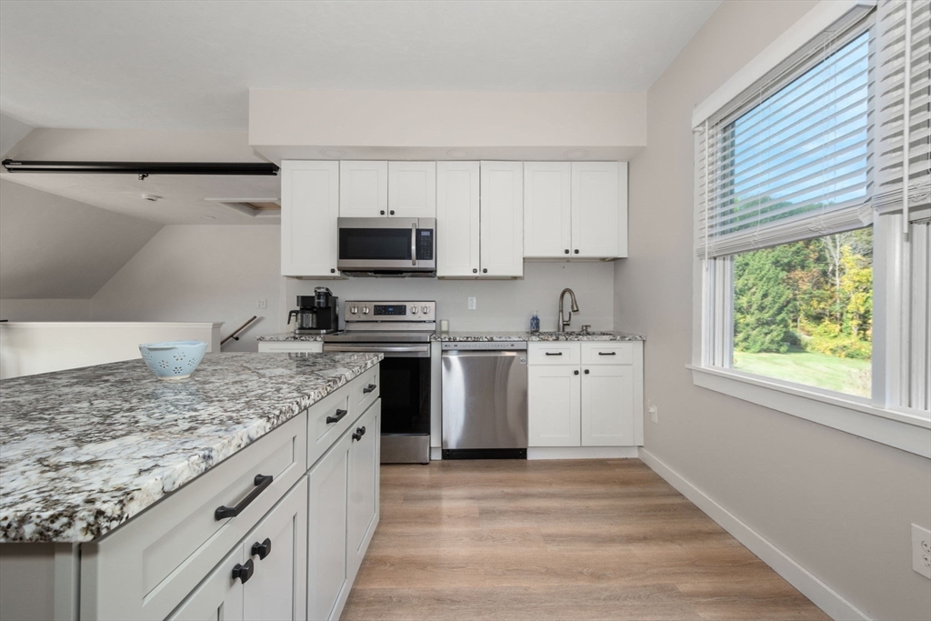 133 Dresser Hill Road Charlton, MA 01507 - Photo 26 of 42 a kitchen with white cabinets and appliances