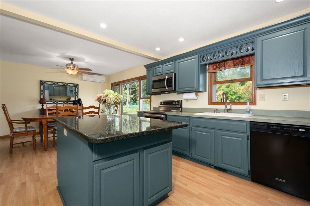 133 Dresser Hill Road Charlton, MA 01507 - Photo 10 of 42 a kitchen with kitchen island granite countertop a sink stove and cabinets