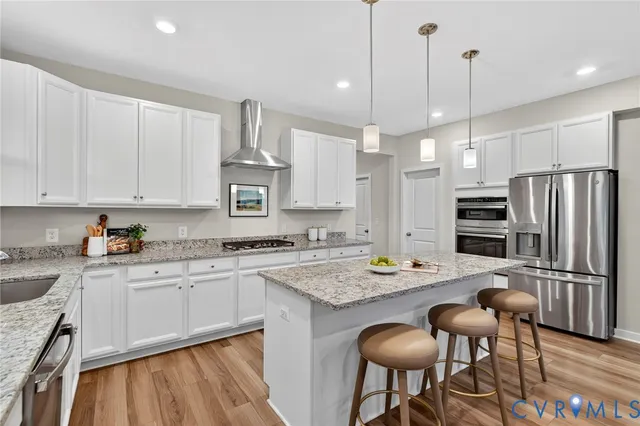 a kitchen with stainless steel appliances granite countertop a stove refrigerator sink and cabinets