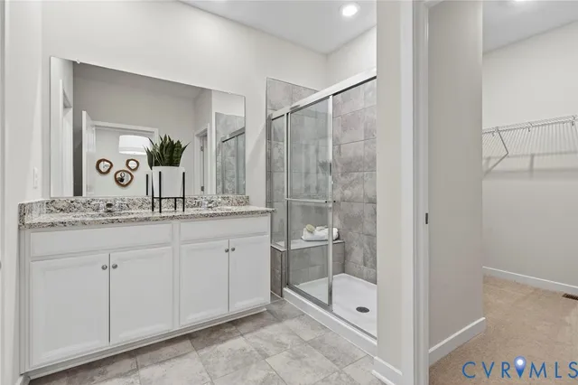 a bathroom with a shower sink and mirror