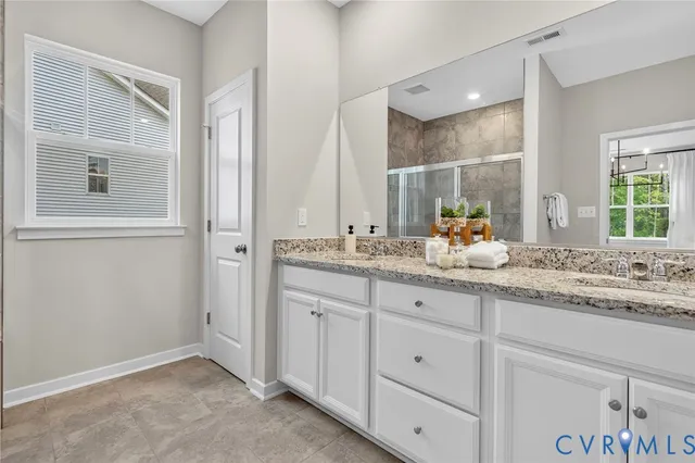 a bathroom with a granite countertop sink mirror and double