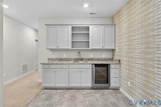 a bathroom with a granite countertop sink and a stove