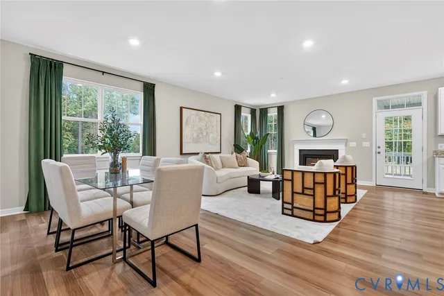 a living room with furniture a fireplace and a table