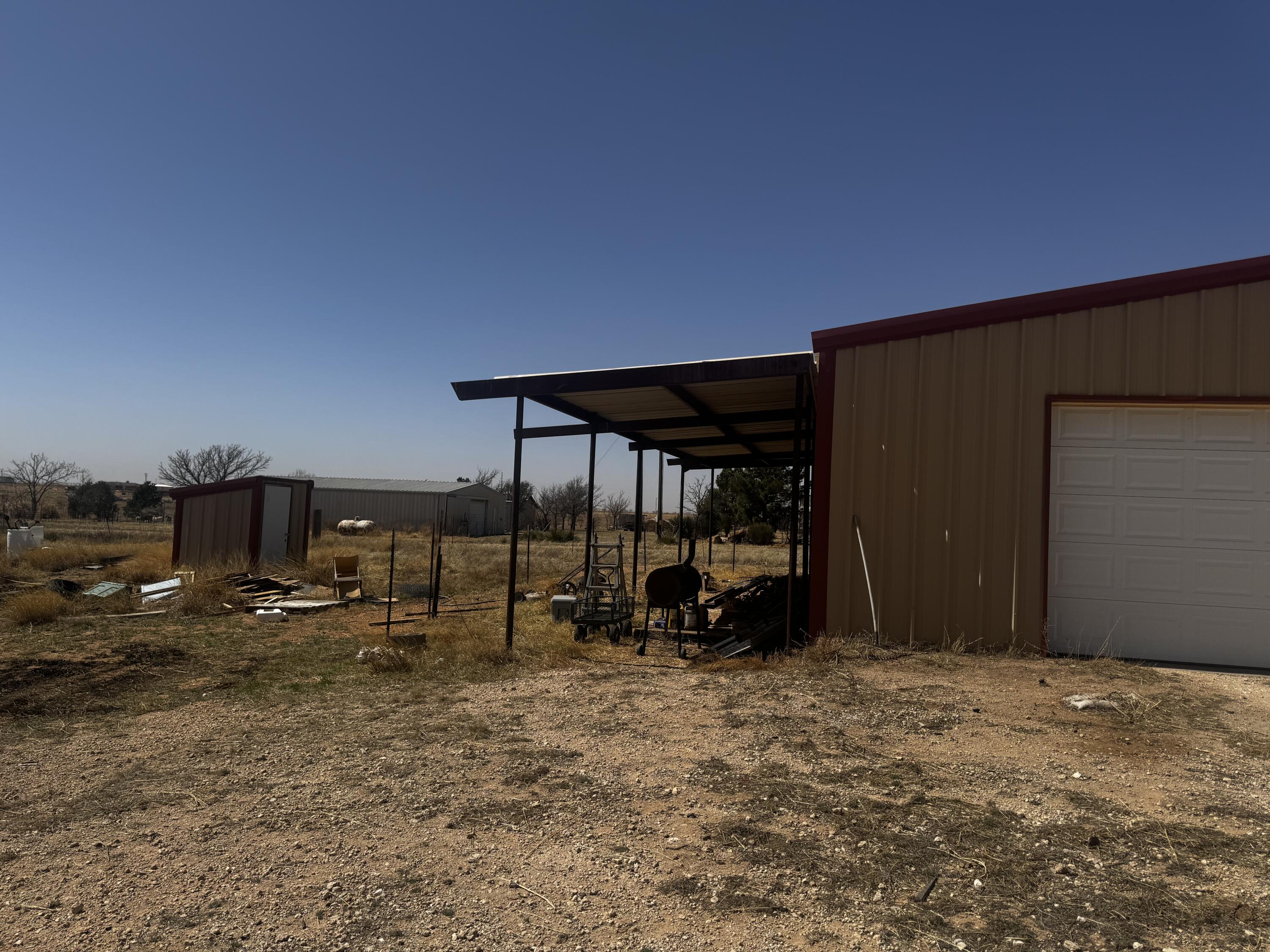 1128 Alaska Road Levelland, TX 79336 - Photo 6 of 20 a backyard of a house with barbeque oven table and chairs