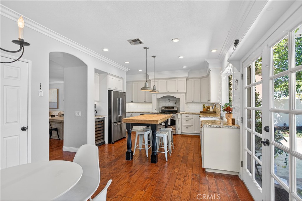 31928 Cercle Chambertin Temecula, CA 92591 - Photo 30 of 74 a open kitchen with stainless steel appliances granite countertop a refrigerator a stove top oven a dining table and chairs with wooden floor