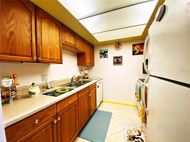 a kitchen with stainless steel appliances a stove a refrigerator and cabinets