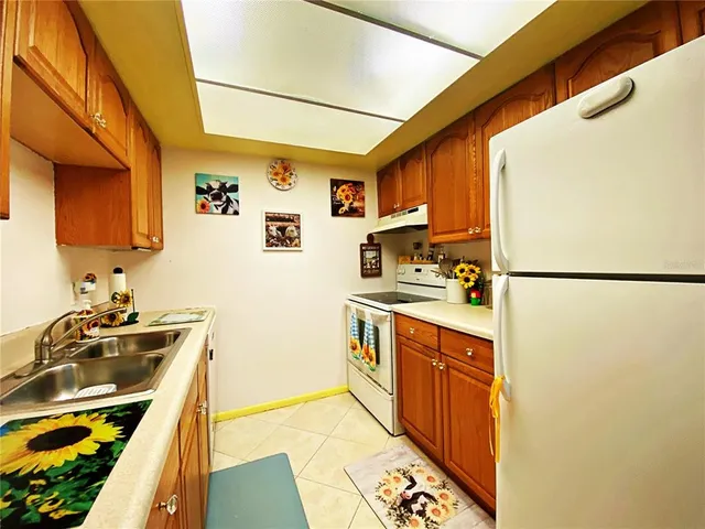 a kitchen with stainless steel appliances a stove a sink and a refrigerator
