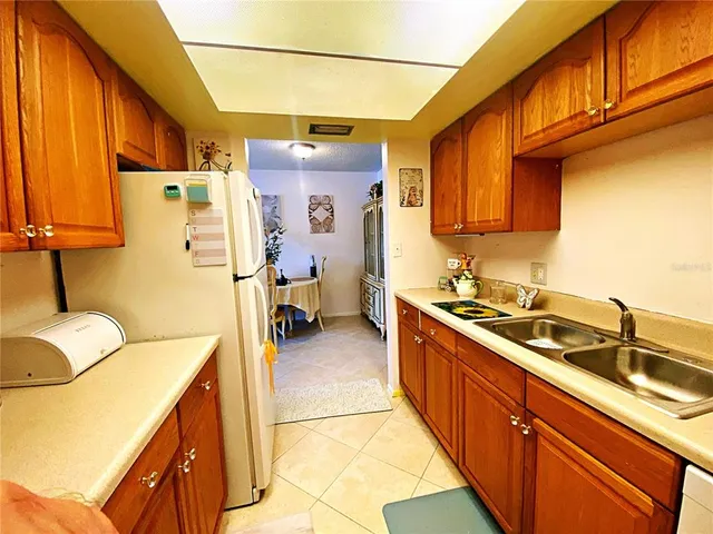 a kitchen with a sink appliances and cabinets