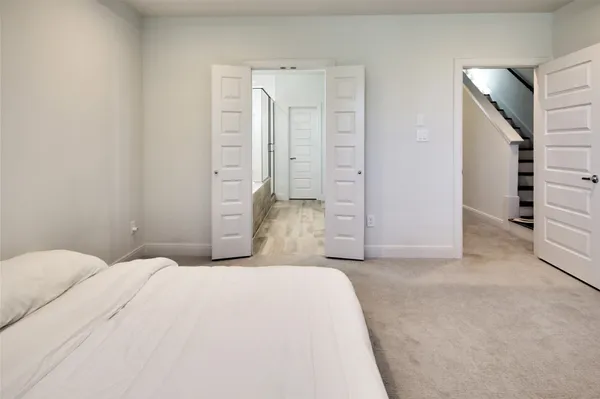 a bedroom with a bed and cabinets