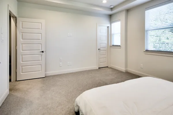 a spacious bathroom with a tub sink and mirror