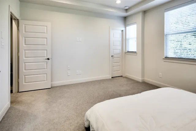 a spacious bathroom with a tub sink and mirror